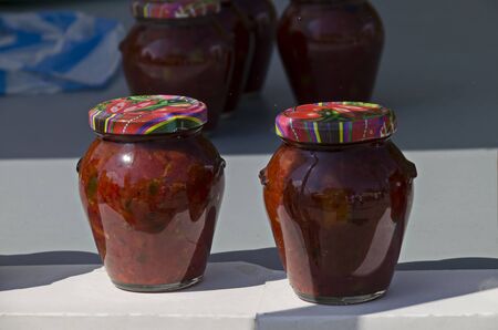 Glass jar with traditional home-made classic spicy salsa tomato, chili, garlic and pepper  on fire, Sofia, Bulgariaの写真素材