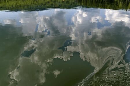 Natural reflection on Vlasina Mountain Lake and beautiful cloudy sky, Southeastern Serbia, Europe