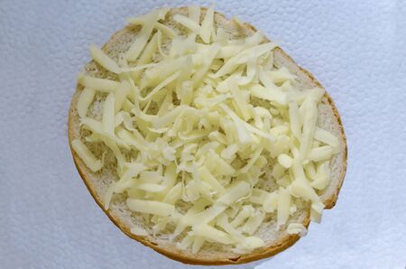 Sliced ââbread with grated yellow cheese or  kashkaval and butter for breakfast, Sofia, Bulgariaの写真素材