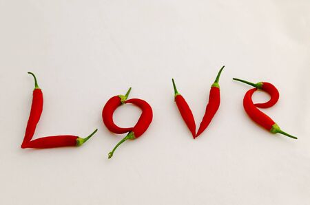 Sign or symbol Love, made from the fruit of fresh chilli red pepper with a green stalk, Sofia, Bulgariaの写真素材