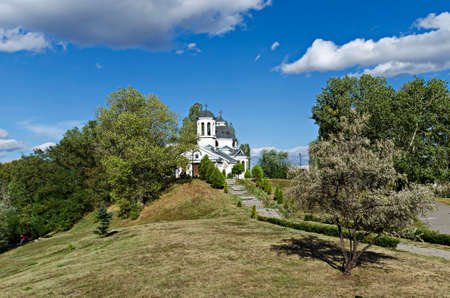 Autumn panorama of a part of a residential district neighborhood with a church with modern...