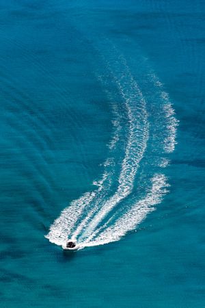 motorboat with an arched track at seaの写真素材