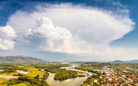 Valley with river and mountain background under blue sky with unusual cloud, Albania - Europe.の写真素材