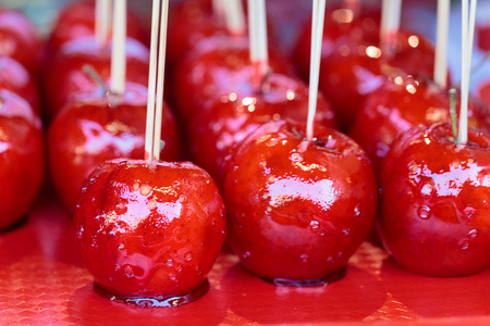 Red sweet candy apples on a sticks at the Christmas marketの写真素材