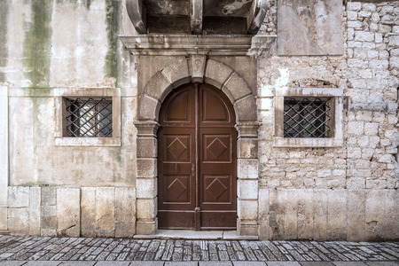 Entrance door of an ancient building in Porec town, Croatia, Europe.の写真素材
