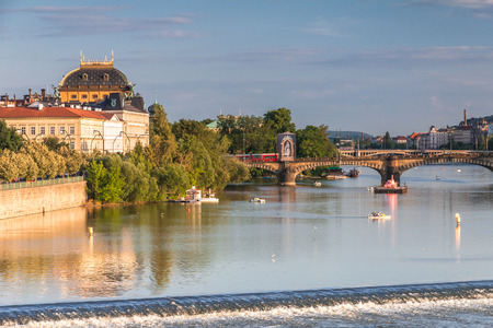 Vltava river and waterfront of the old town with the theater in Prague at sunset, Czech Republic, Europe.の写真素材