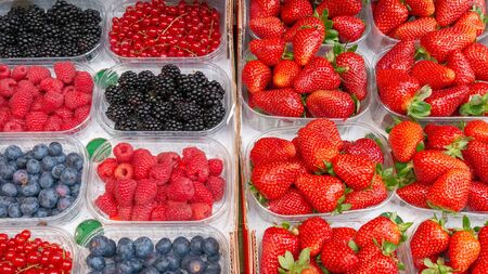 Fresh strawberries, blueberries, currants and raspberries. Fruits prepared for sale.