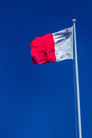 Flag of Malta on flagpole.