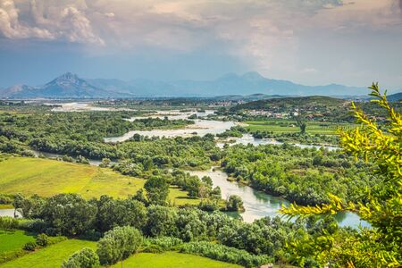 Landscape with river basin and mountain range on background near Shkoder town, Albania, Europe.の写真素材