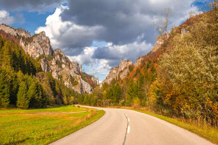 Road through a rocky gorge in a mountain valley at autumn. The Vratna valley in Mala Fatra national...