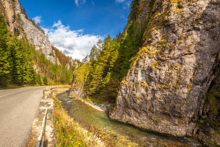 Road through a rocky gorge in a mountain valley at autumn. The Vratna valley in Mala Fatra national park, Slovakia, Europe.の写真素材