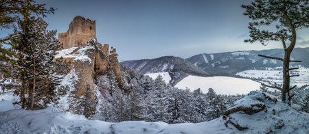 Panoramic view of The medieval castle Lietava on a rocky reef with view of the surrounding landscape in winter, Slovakia, Europe.の写真素材