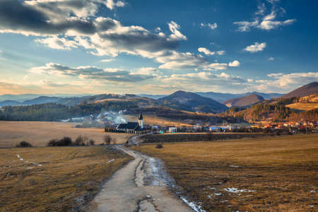 A village in the middle of a rural hilly landscape. The village of Zastranie in the north of Slovakia, Europe.の写真素材