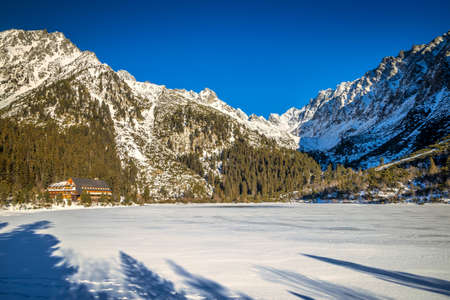 Mountain landscape with frozen tarn at winter season. The Popradske pleso lake in High Tatras National Park, Slovakia, Europe.の写真素材