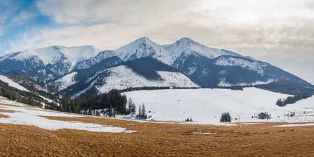 View of the landscape with snowy mountains and ski slopes. Ski resort Striednica in Zdiar village, High Tatras National Park, Slovakia, Europe.の写真素材