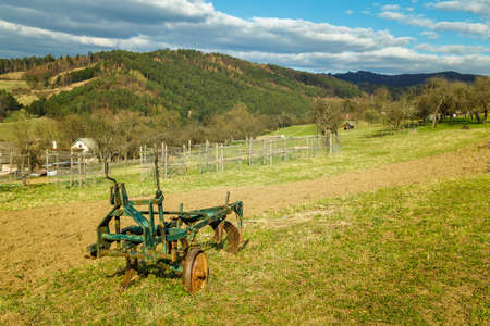 Agricultural plow on the edge of the field, rural landscape in spring.の写真素材
