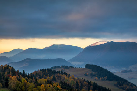 Beautiful sunrise in the mountainous rural landscape in autumn. The Mala Fatra national park in northwest of Slovakia, Europe.の写真素材