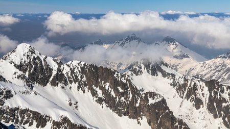 Snowy winter high mountain landscape. A panoramic view from the top of The Lomnicky peak in High Tatras National Park, Slovakia, Europe.の写真素材