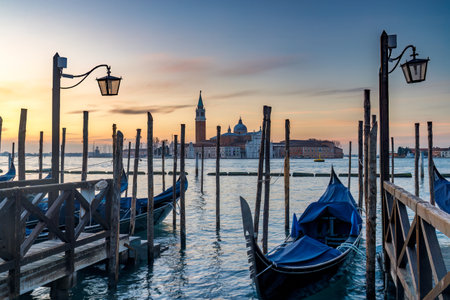 View of San Giorgio Maggiore Island with gondolas from San Marco square in Venice at sunrise, Italy, Europe.の写真素材