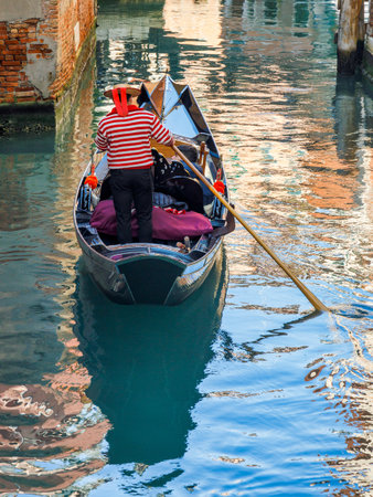 Gondola with passengers on the canal in Venice, Italy, Europe.の写真素材
