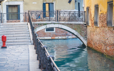Stone bridge over the canal in Venice, Italy, Europe.の写真素材