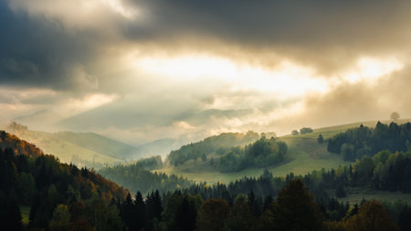 Autumn misty mountainous landscape with morning sun rays shining through the clouds. The Orava region of Slovakia, Europe.の写真素材