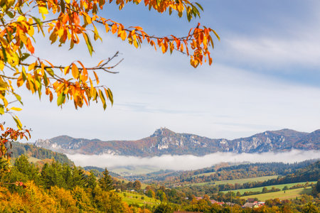 A landscape with mountains surrounded by fog in the autumn season. The Sulov Rocks, national nature reserve in northwest of Slovakia, Europe.の写真素材