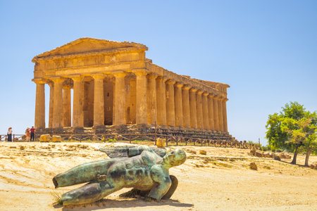 AGRIGENTO, ITALY - JULY 11, 2023: Temple of Concordia with bronze statue in Valley of the Temples. Archaeological site at Sicily.のeditorial素材