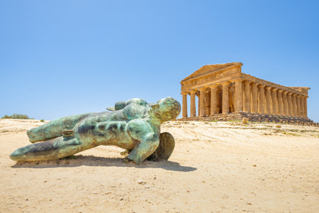 AGRIGENTO, ITALY - JULY 11, 2023: Temple of Concordia with bronze statue in Valley of the Temples. Archaeological site at Sicily.のeditorial素材