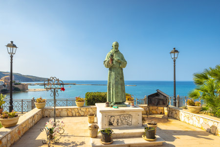 CASTELLAMMARE DEL GOLFO, ITALY - JULY 13, 2023: Padre Pio statue on the coast.のeditorial素材