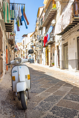 CEFALU, ITALY - JULY 16, 2023: Vespa motorcycle in a street.のeditorial素材
