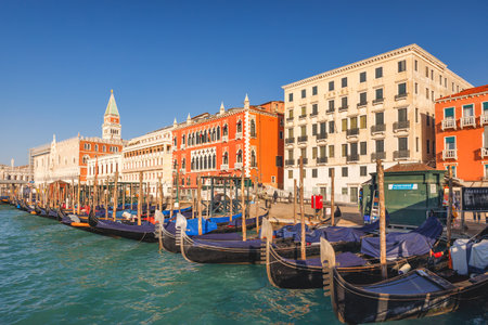 VENICE, ITALY - MARCH 4, 2023: The embankment with palaces and gondolas at sunny morning.のeditorial素材