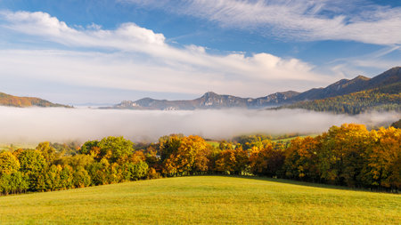 A landscape with mountains surrounded by fog in the autumn season. The Sulov Rocks, national nature reserve in northwest of Slovakia, Europe.の写真素材