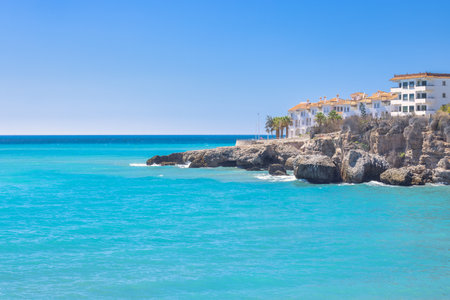Nerja town, a resort of The Costa del Sol seaside region in Andalusia in the south of Spain. Coastal villas overlooking a turquoise sea on a sunny day. Relaxing beach view.の写真素材