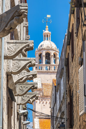 Korcula town in island of Korcula in Adriatic sea in Croatia, Europe. Historic architecture featuring ornate stone carvings and a prominent dome against a bright blue sky in a European cityscape.の写真素材