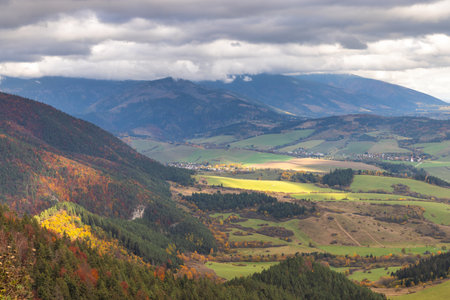 Panoramic view of a valley landscape under a cloudy sky. Mountains are in the distance. The Liptov region in Slovakia, Europe.の写真素材