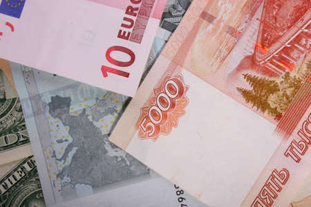 The money - the euro, dollars, rubles, scattered on the tableの写真素材