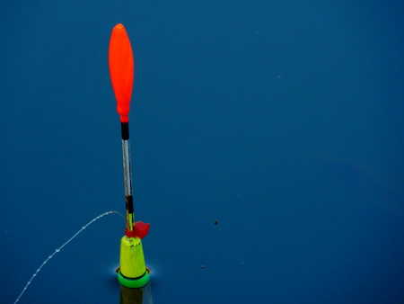 colorful fishing bobber in the waterの写真素材