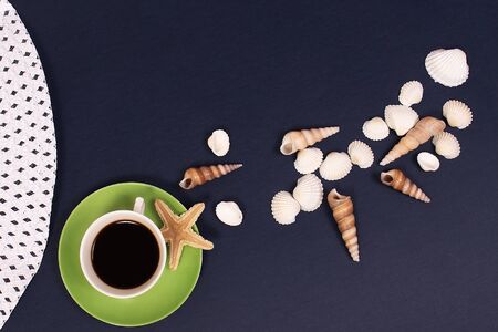 the cup of coffee and sea shells on a blue background