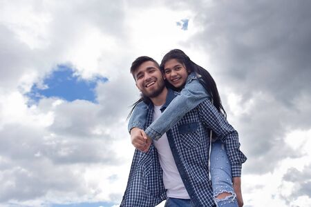 the Dad and daughter against the sky, photo for Father's Day