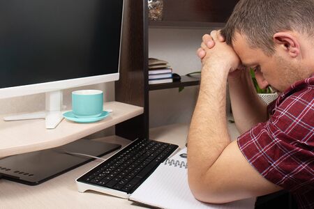 the man at the computer, heavy stress over finances