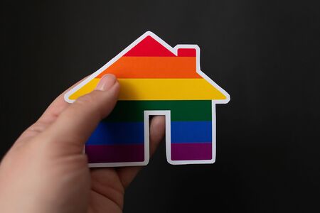 the rainbow house lgbt in hands on a black backgroundの写真素材