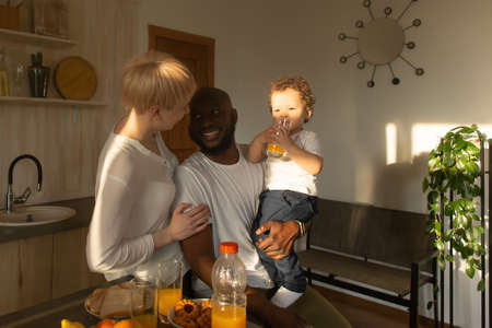the happy family having dinner, different nationalitiesの写真素材