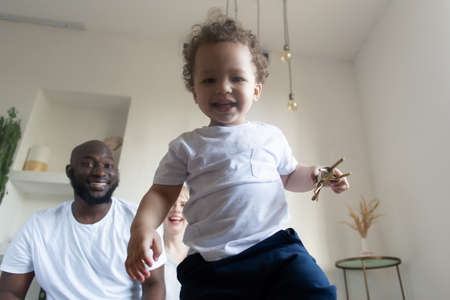 the happy family at home, different nationalitiesの写真素材