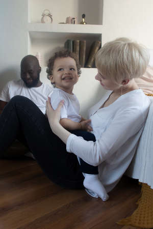 the happy family at home, different nationalitiesの写真素材