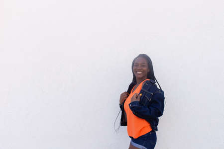 the Happy African American dances against white wall