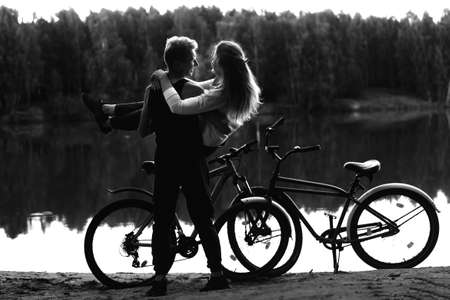 the Couple in love on the beach with bikes, black and white photoの写真素材