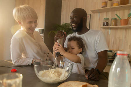 the happy family having dinner, different nationalitiesの写真素材