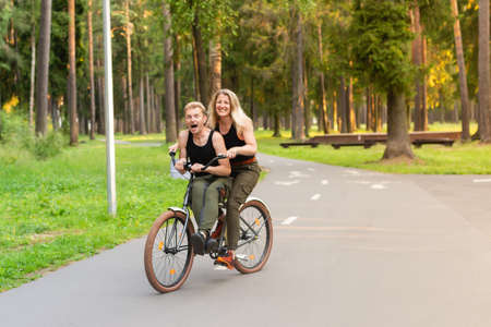 the Happy couple on bikes in the parkの写真素材