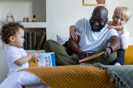 the happy family at home, different nationalitiesの写真素材